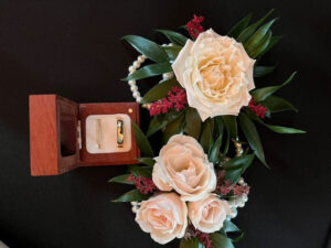 Styled photo from a Middleburg Barns wedding with the rings and a beautiful floral arrangement