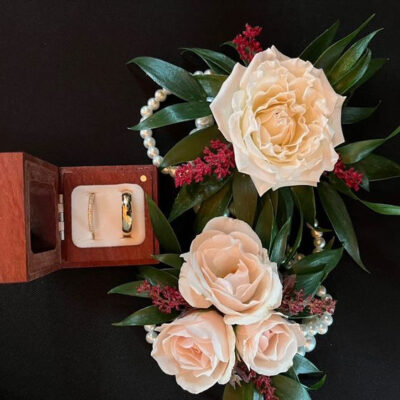 Styled photo from a Middleburg Barns wedding with the rings and a beautiful floral arrangement