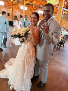 A Middleburg beautiful black bride and groom holding their hands up to show their wedding rings